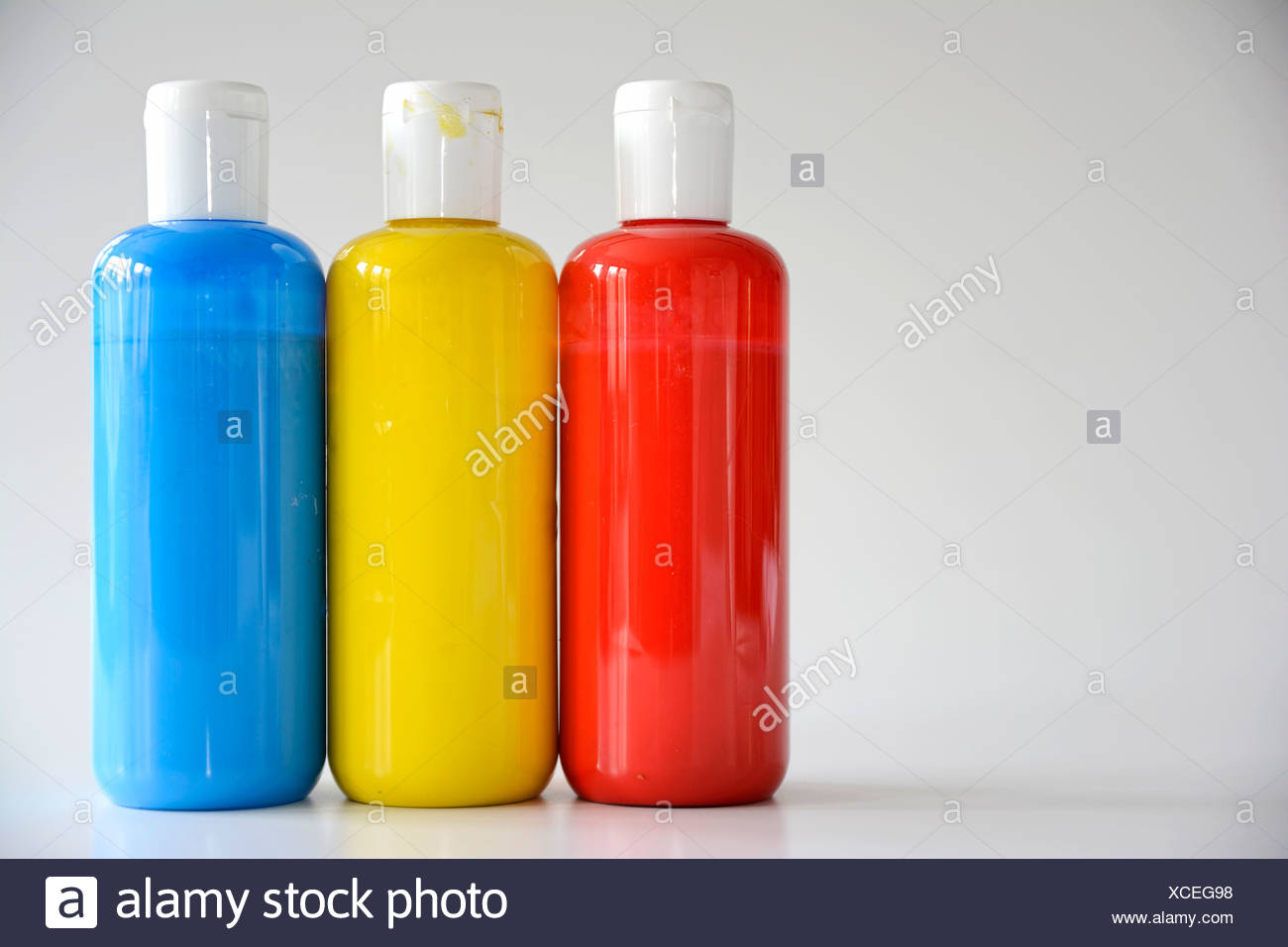 Download Red Yellow Blue Bottles On Gray Background Stock Photo Alamy Yellowimages Mockups