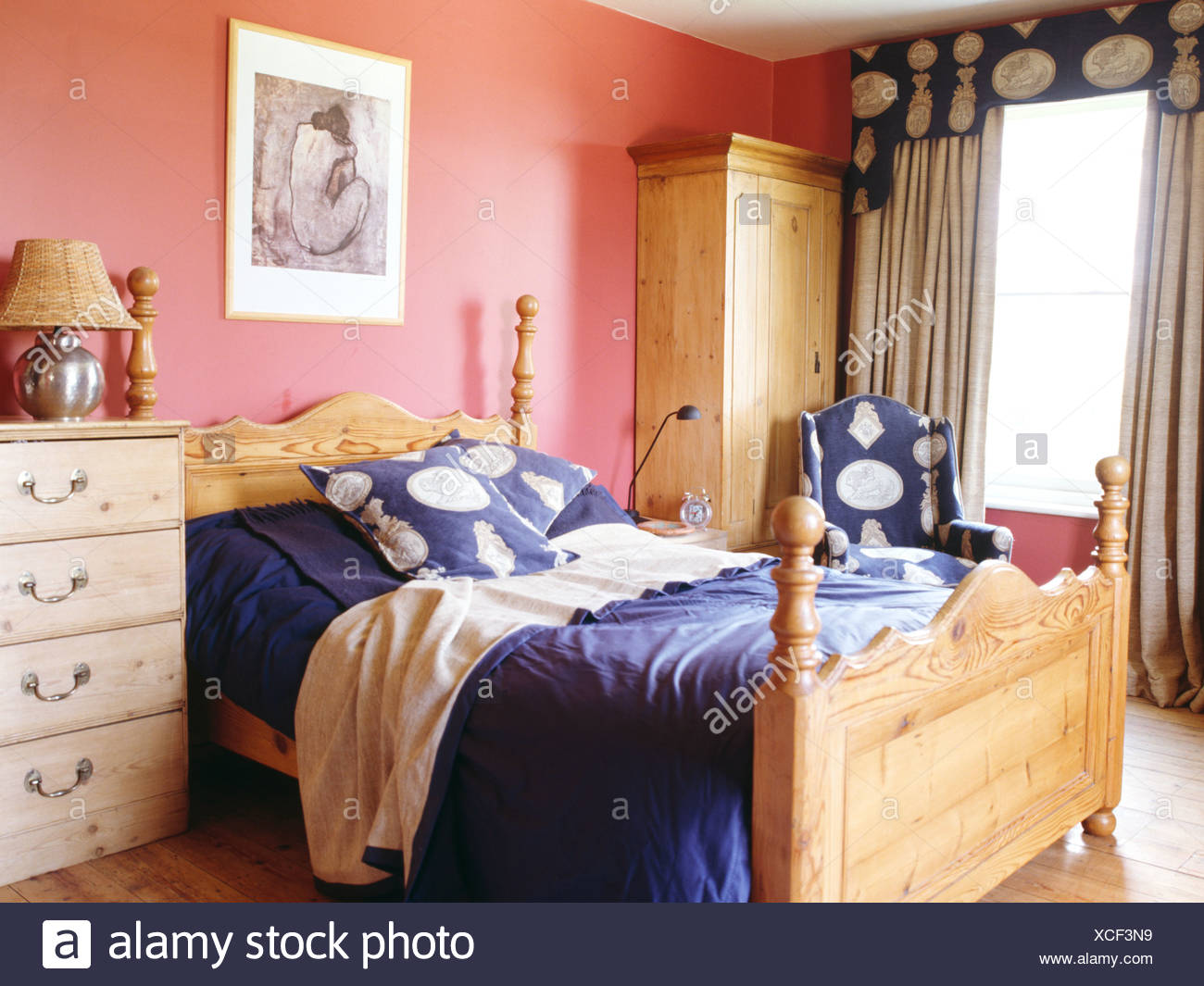 Pine Bed With Blue Cushions And Bedlinen In Pink Bedroom With Pine