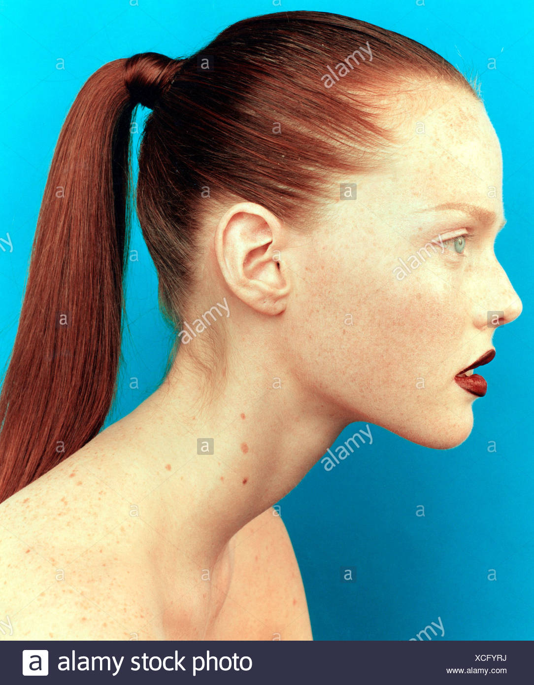 Profile Of Female Straight Red Hair Off Face Pulled Tightly Into