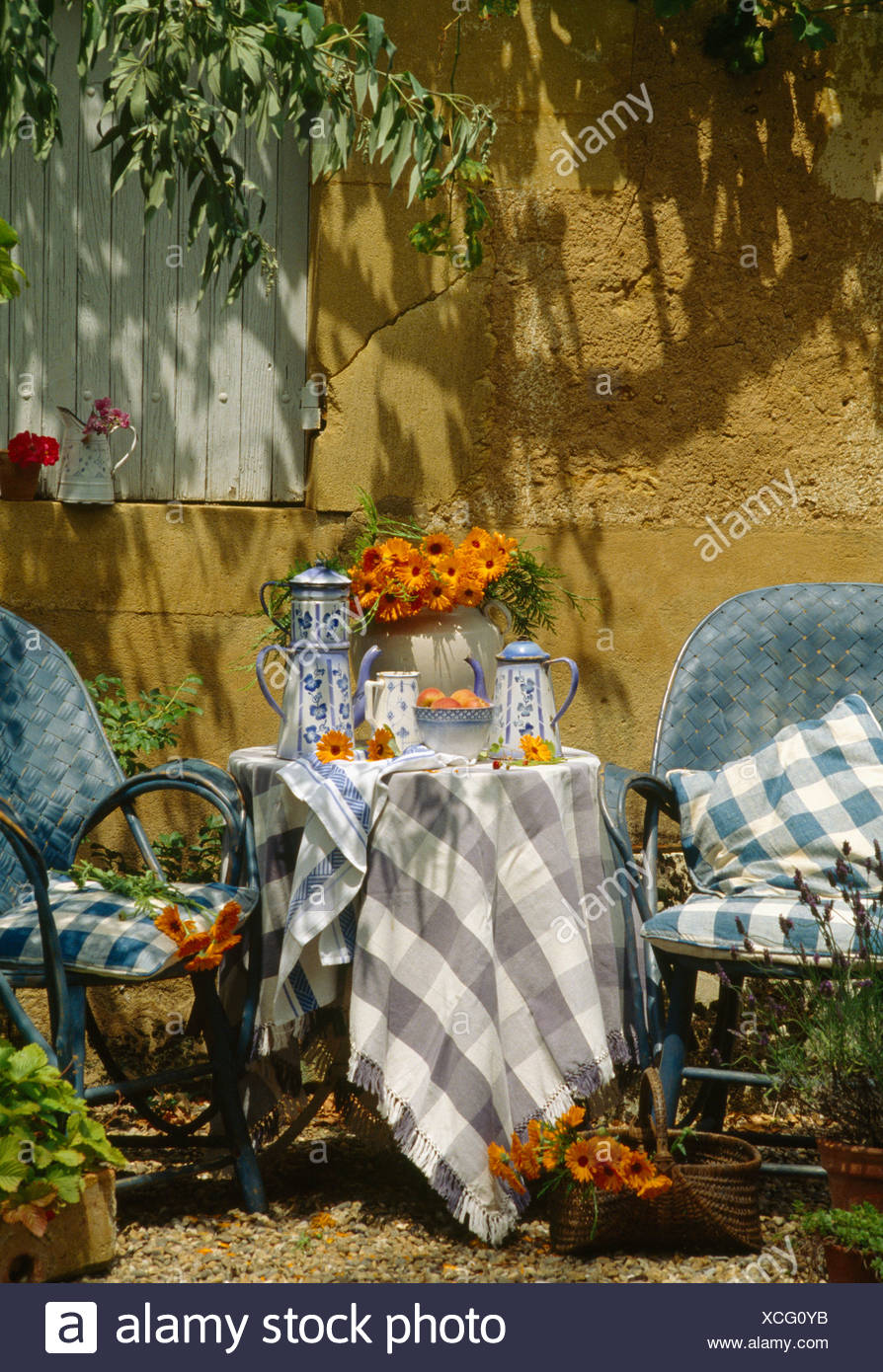 Blue Cane Chairs At Table With Checked Cloth And Blue White