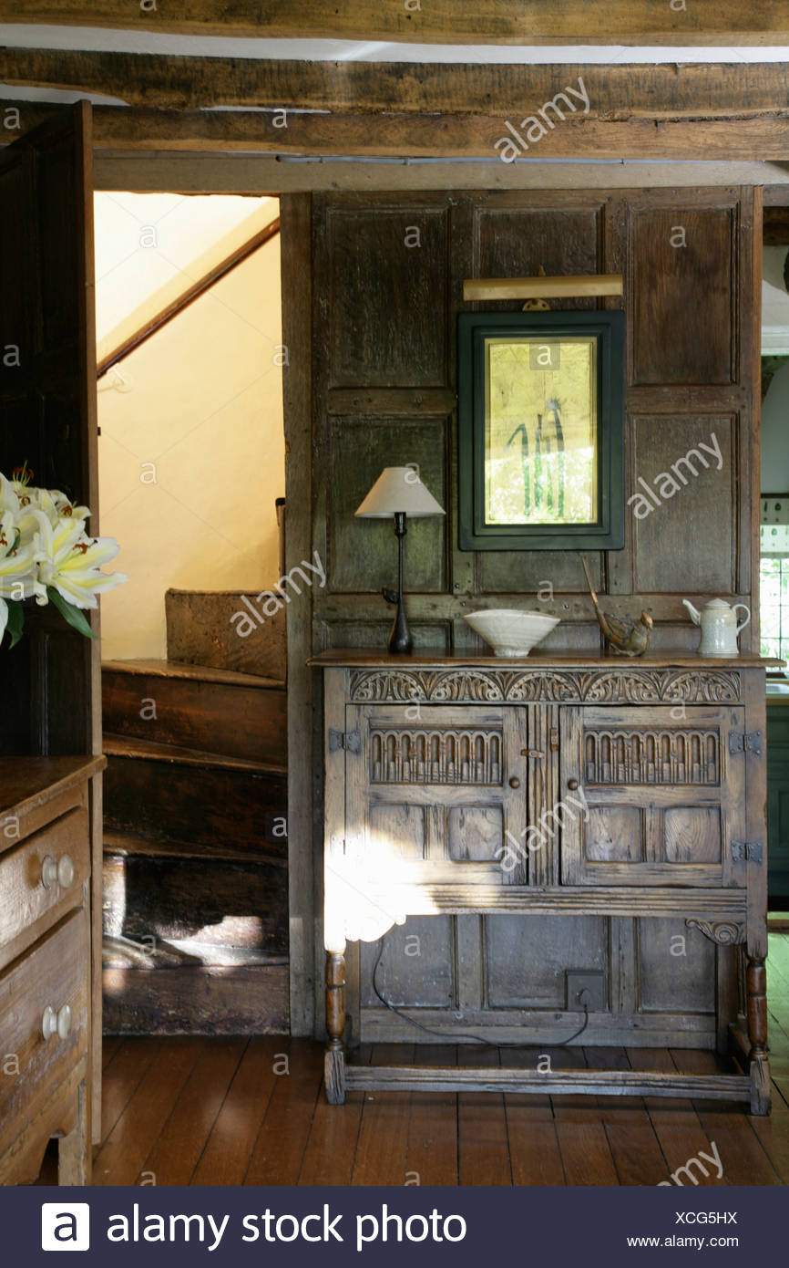 Carved Wooden Cabinet In Country Hall With Oak Staircase And