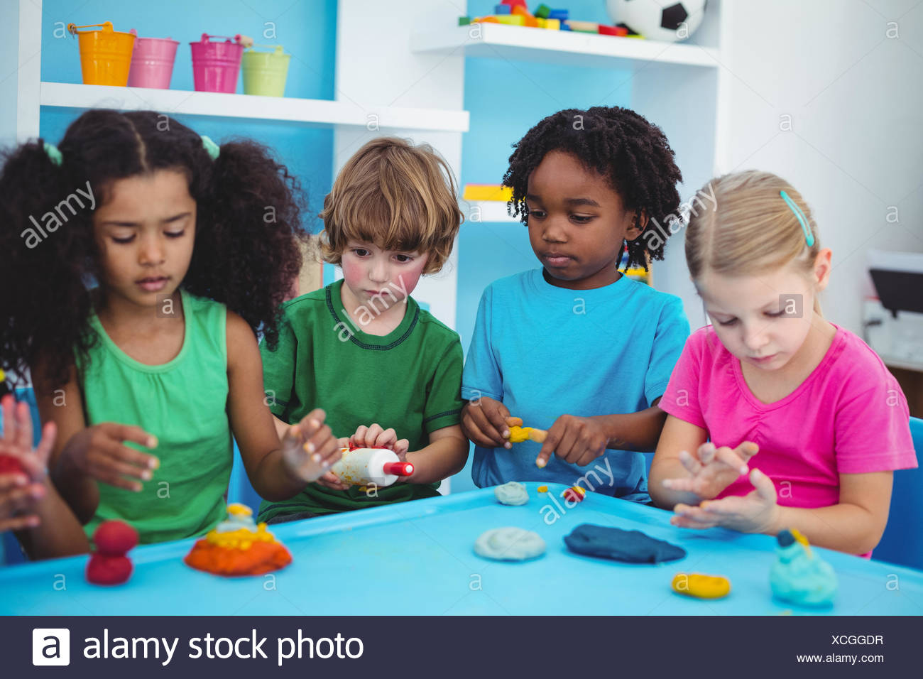 Smiling Kids Playing With Modelling Clay Stock Photo