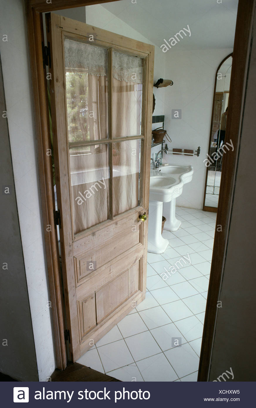 Open Half Glazed Wooden Door To Dining Room With White Tiled