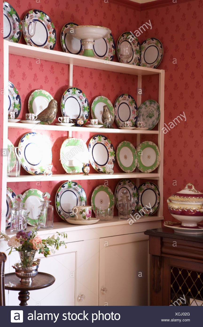 Green Patterned Plates On Built In White Dresser In Diningroom