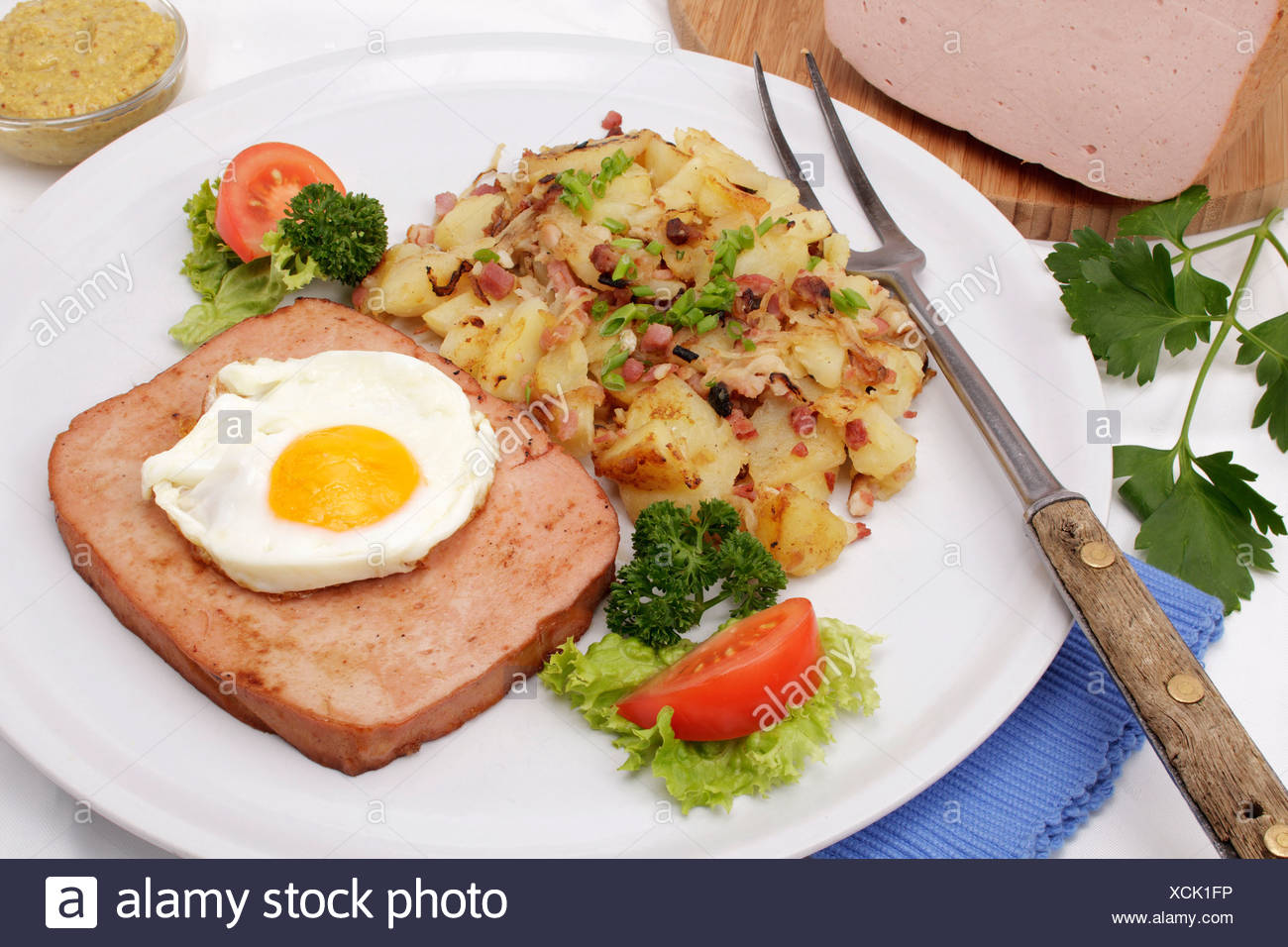 Leberkaese with fried egg and fried potatoes, Bavarian speciality Stock Photo