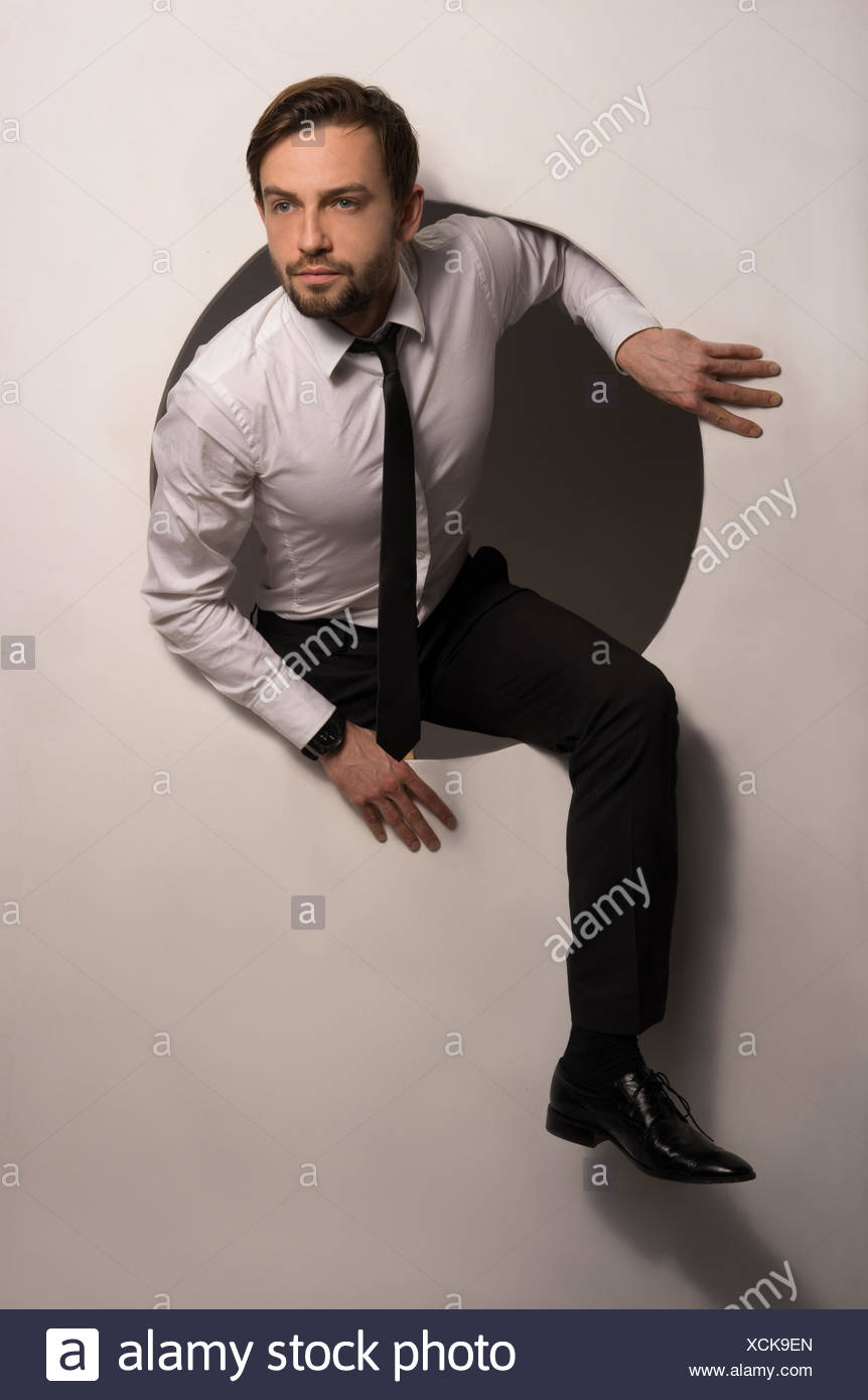 Businessman Climbing Out Of A Circular Hole Businessman Climbing Out Of A Circular Hole