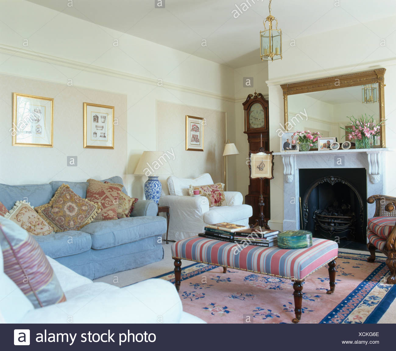 Striped Upholstered Stool On Pink Chinese Rug In Front Of