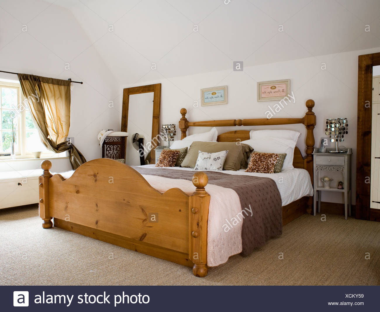 Large Pine Bed With White Bedlinen And Brown Throw In