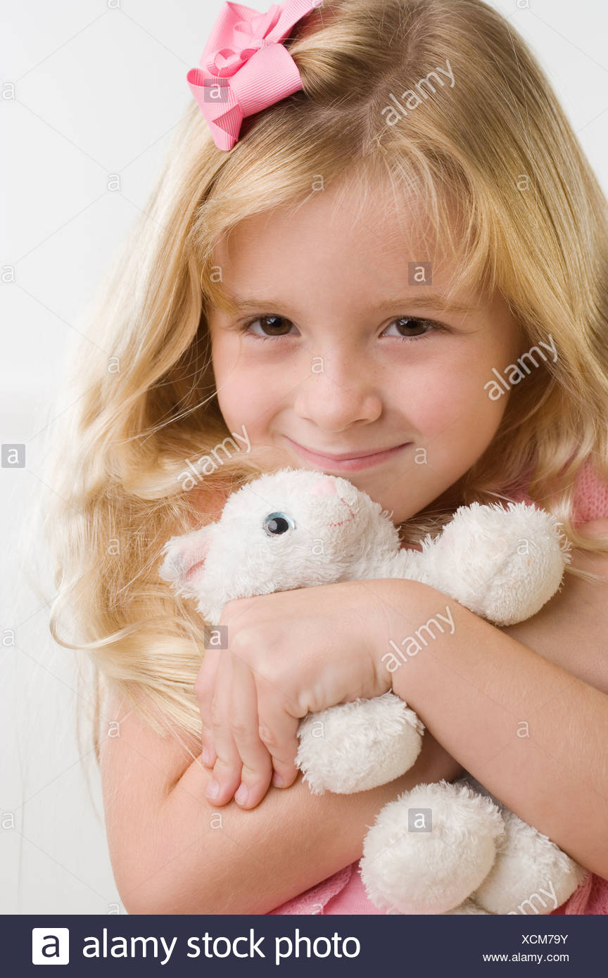 girl hugging stuffed animal