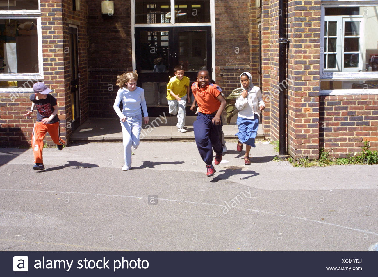 Primary School Children Running Out The School Doors After Lessons