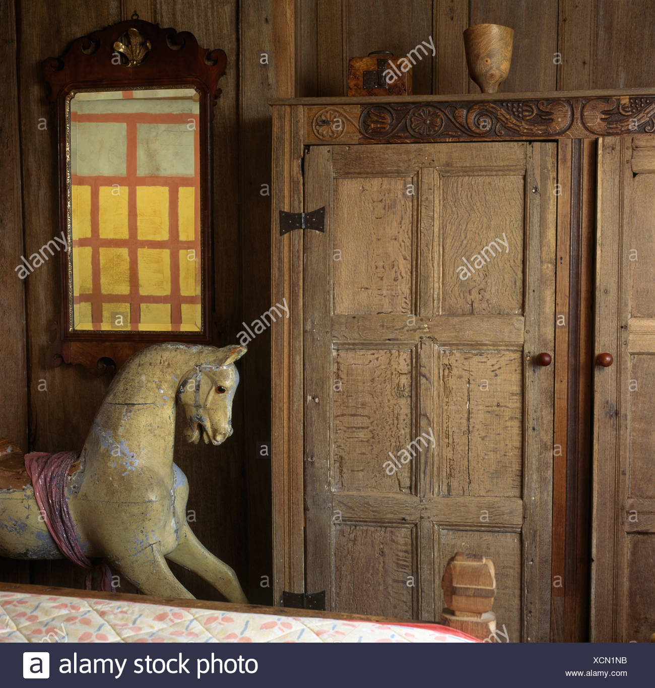 Georgian Mirror And Old Wooden Wardrobe In Oak Paneled
