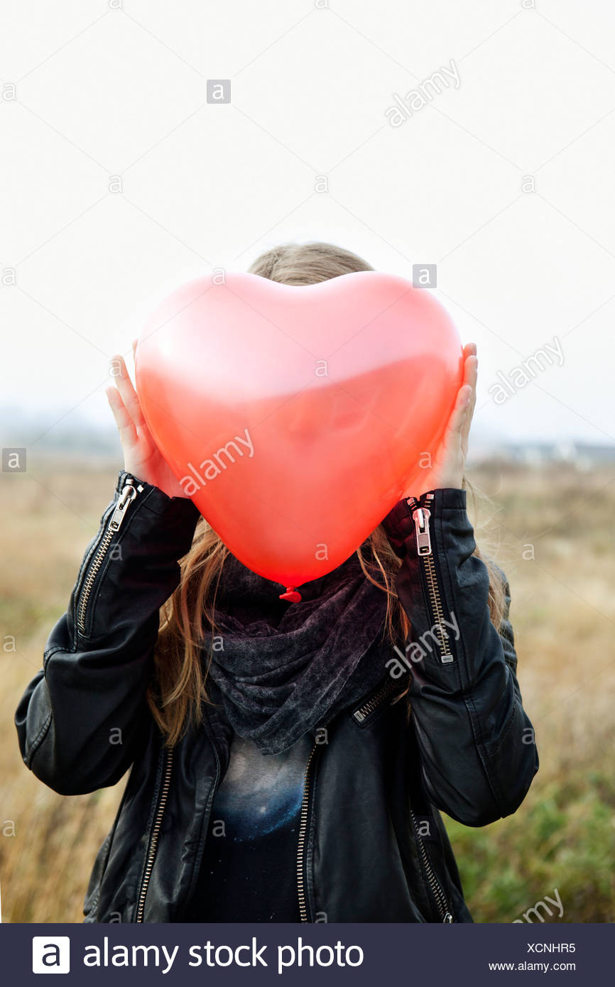 Girl Holding Heart Shaped Balloon Stock Photos & Girl Holding Heart