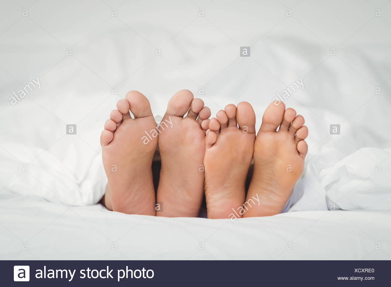 Feet Sticking Out Of Bed High Resolution Stock Photography and Images