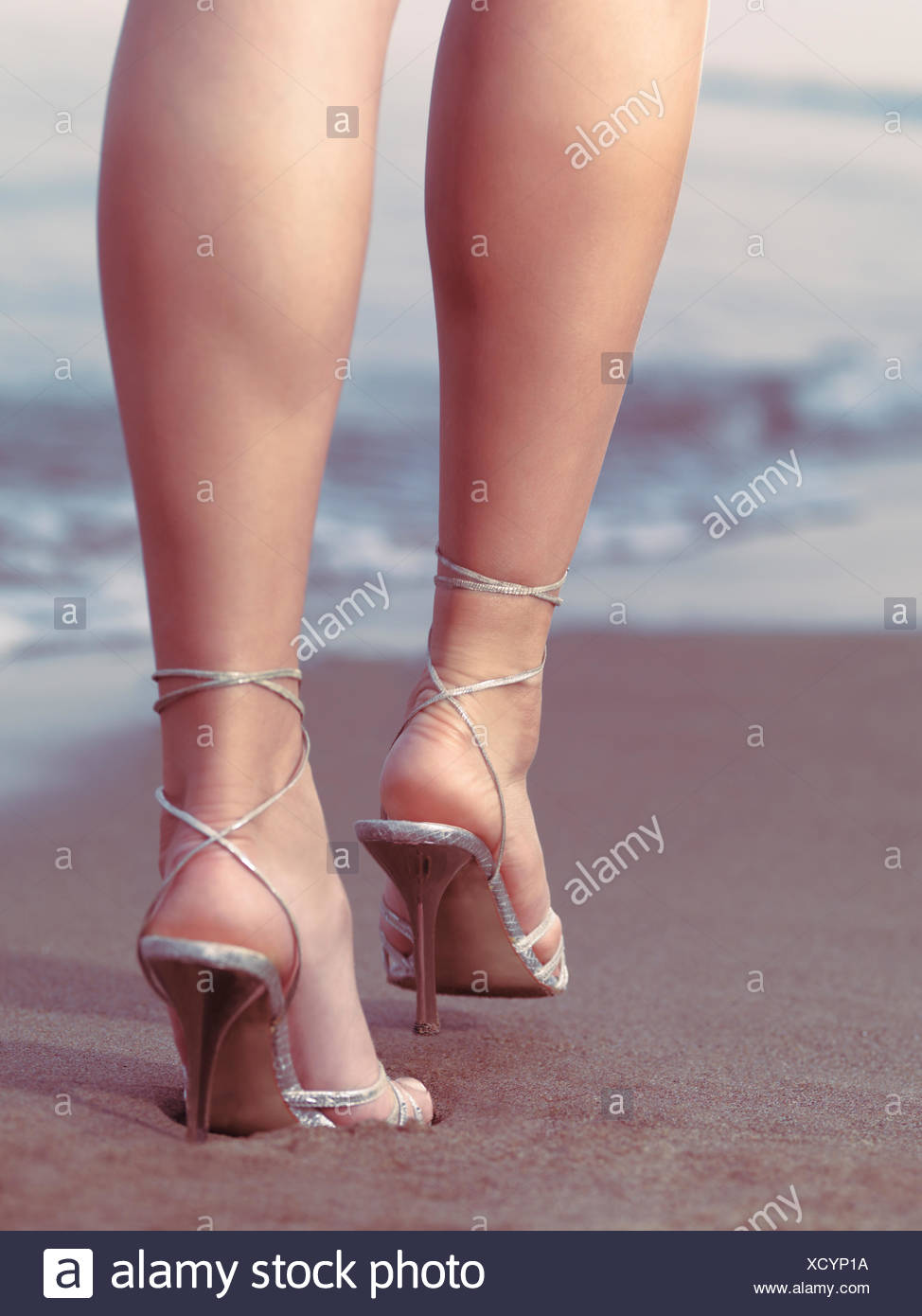 Woman wearing high heels walking on the 