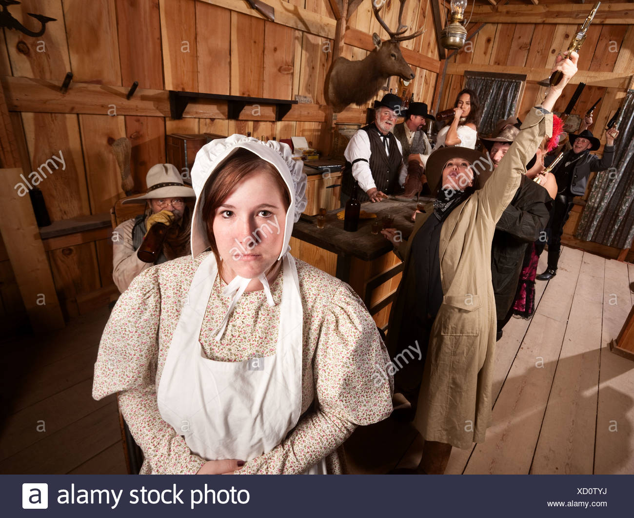 Shy woman with rowdy people in an old west saloon Stock Photo - Alamy