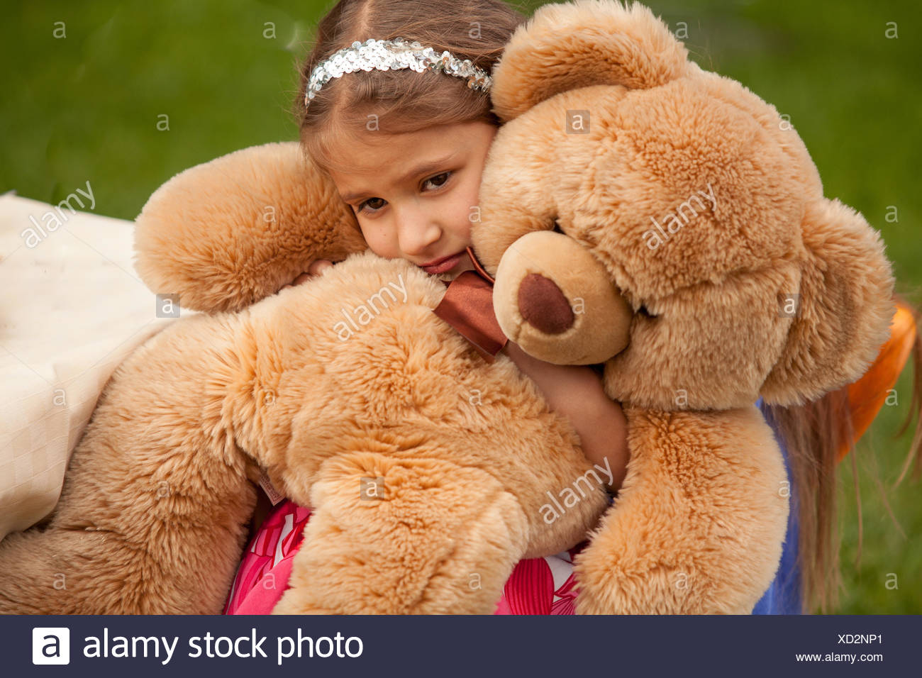 little girl hugging teddy bear