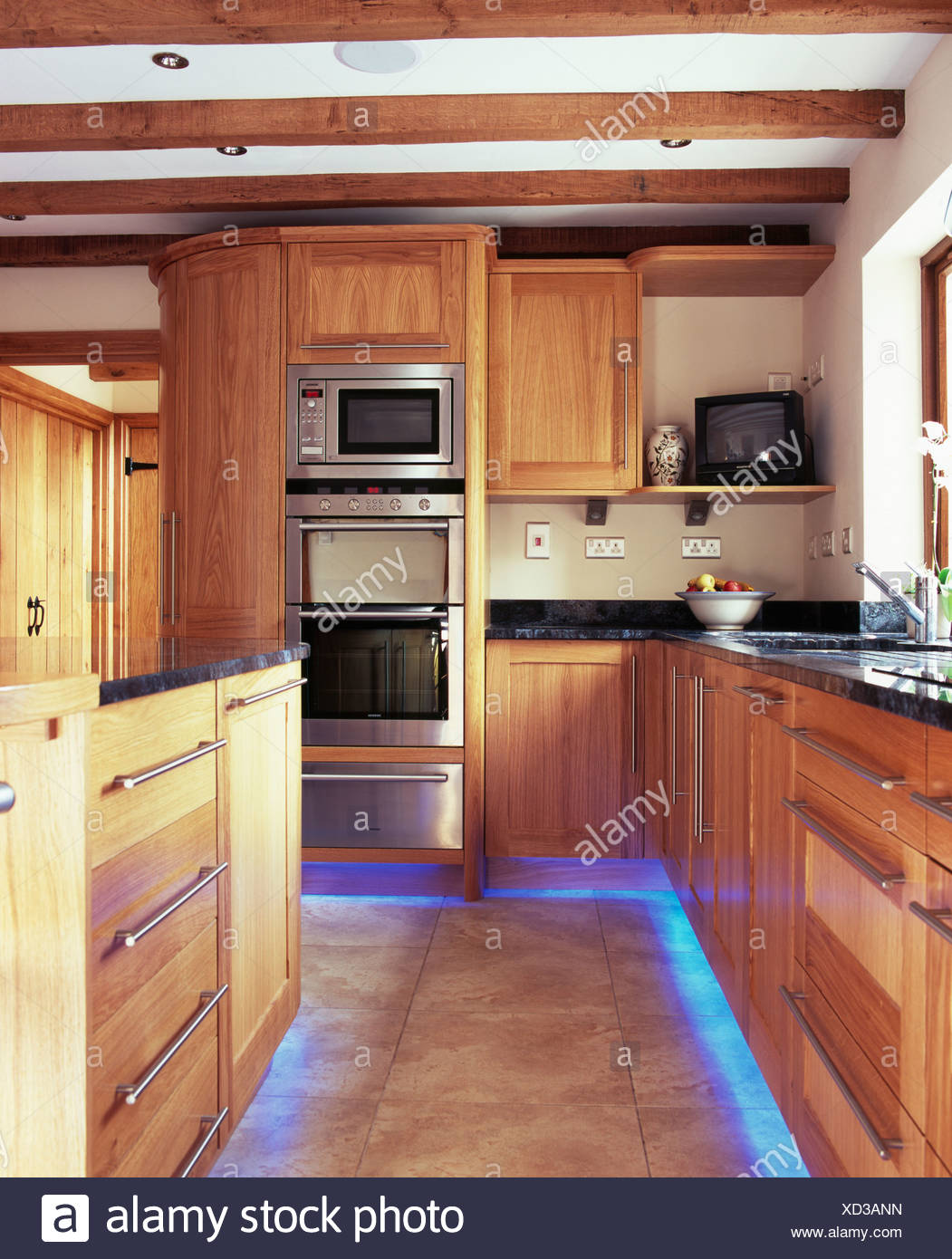 Blue Halogen Lighting Below Fitted Units In Modern Country Kitchen