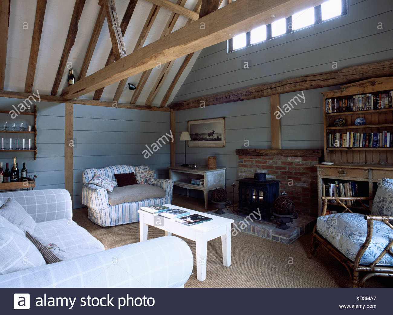 Large Wooden Ceiling Beams And Comfortable Sofas In Pale
