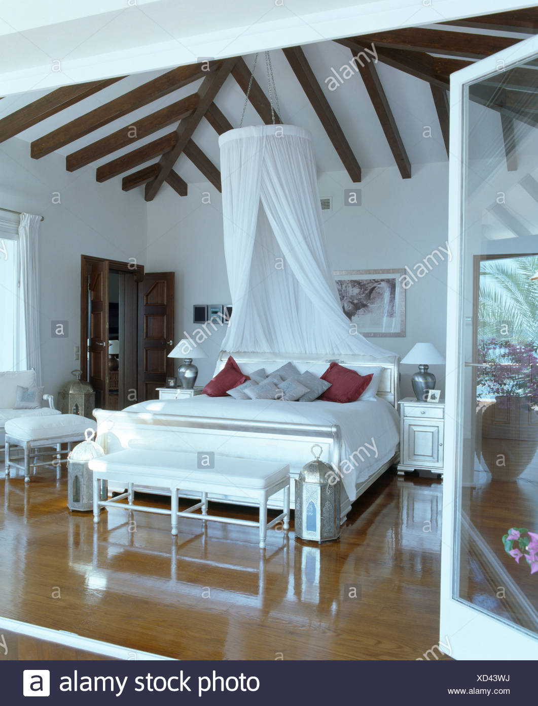 White Voile Drapes On Coronet Above Bed With White Bedlinen