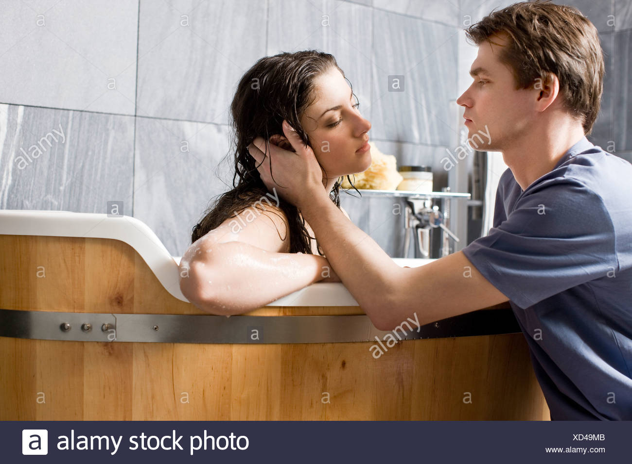 Man Kissing Woman In Bathroom Stock Photo Alamy