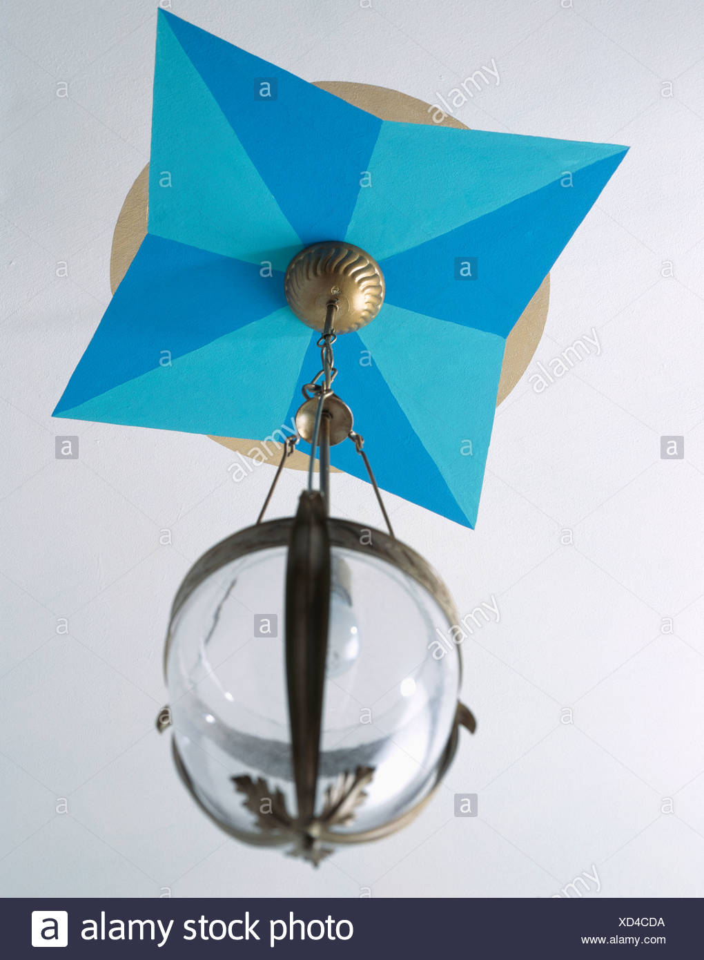 Close Up Of Painted Blue Geometric Patterned Ceiling Rose