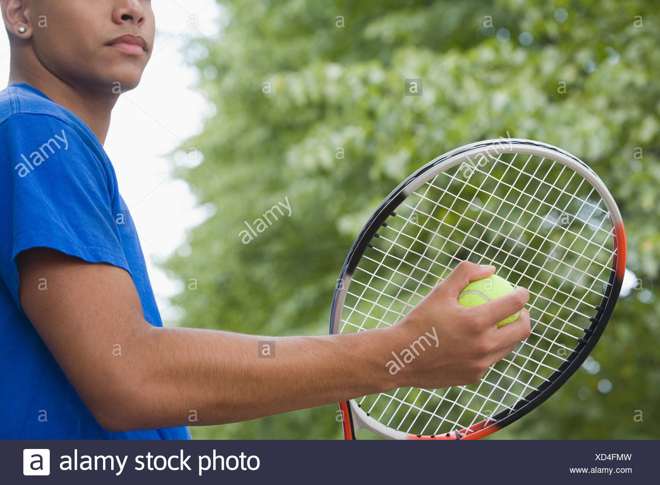 Mid Section View Of A Teenage Boy Holding A Tennis Racket And A Tennis Ball Stock Photo Alamy