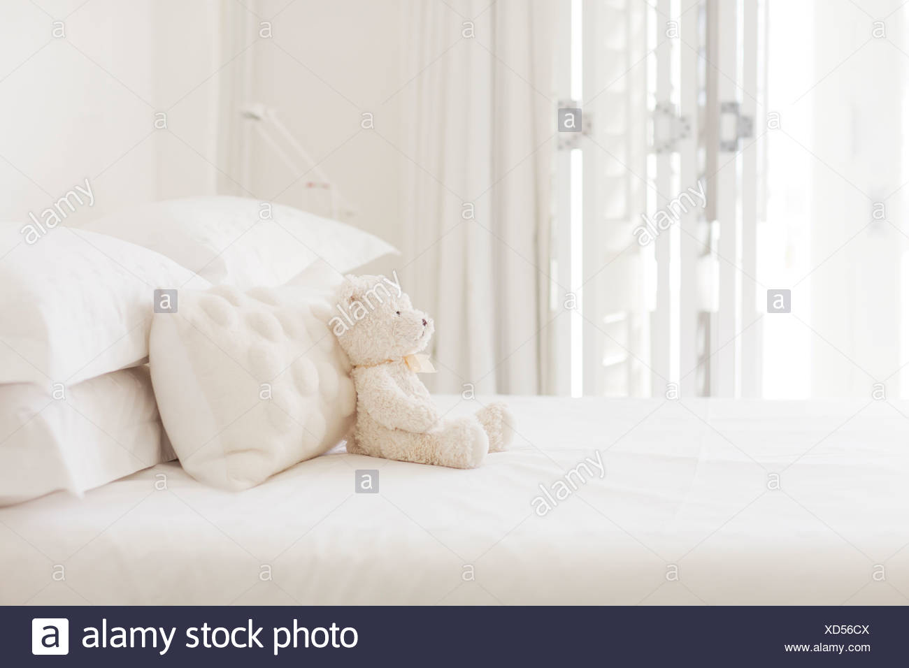 Teddy Bear And Pillows On White Bed Stock Photo 283471242 Alamy