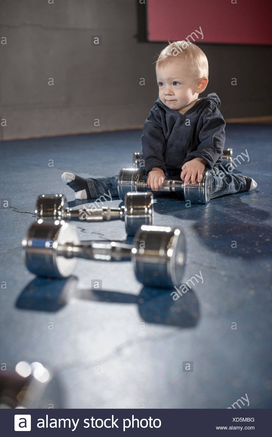baby with dumbbell