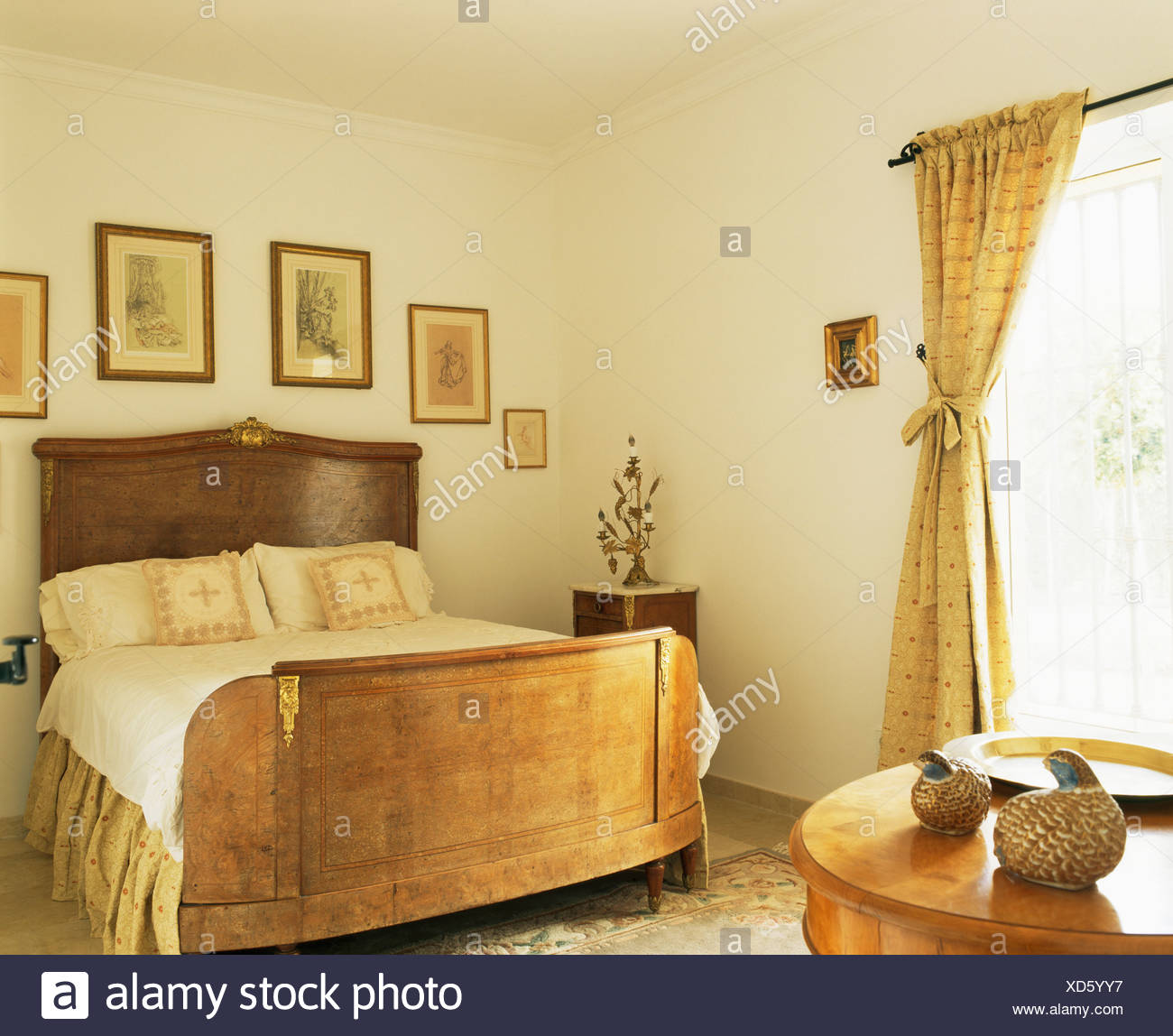 Pictures On The Wall Above Antique Mahogany Bed In Cream