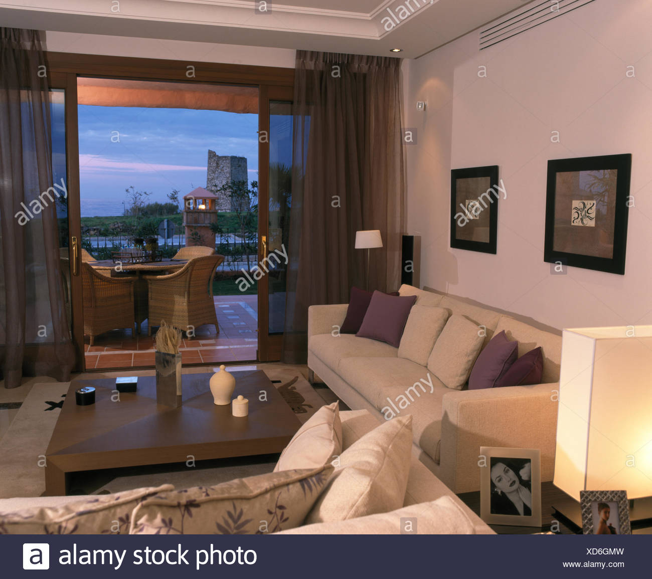 White Sofas In Spanish Living Room With Brown Voile Drapes On Open
