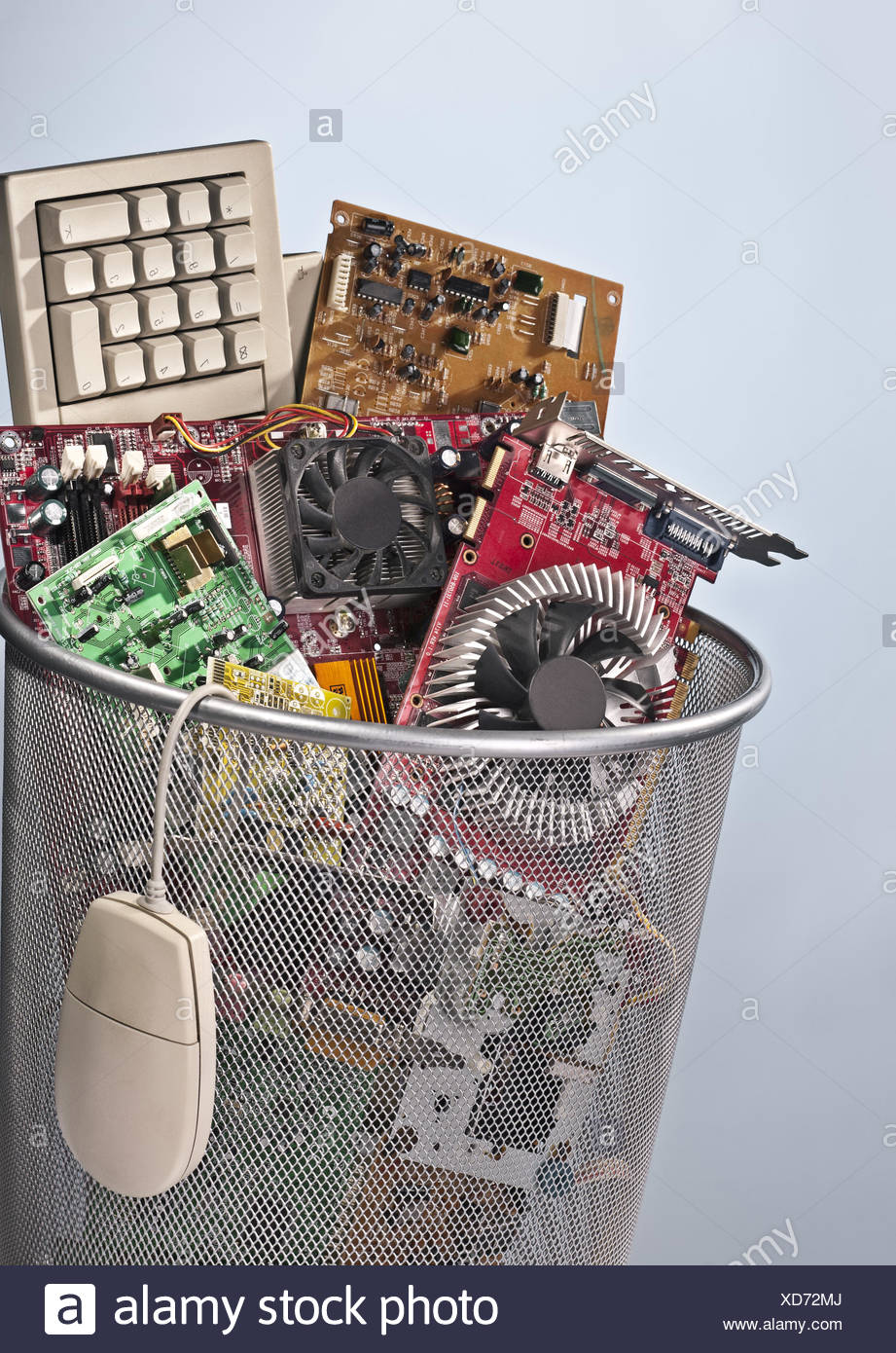 Paper basket full of electronic waste Stock Photo - Alamy