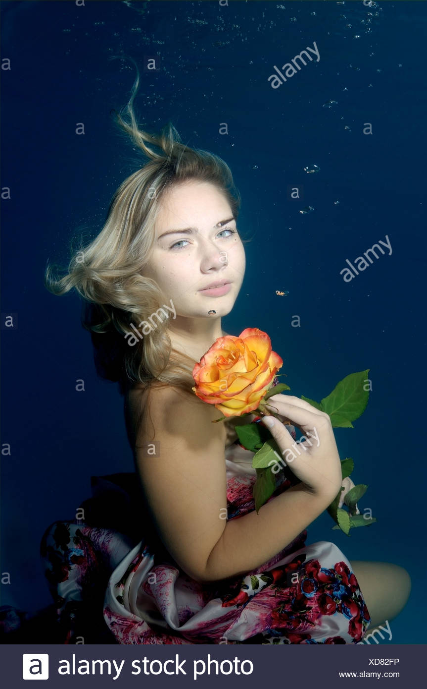 Woman presenting underwater fashion in a pool Stock Photo