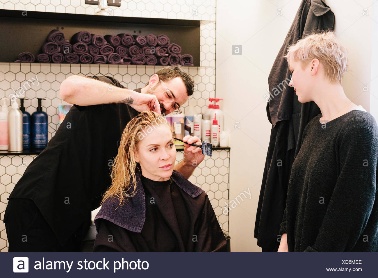 A Hair Stylist Cutting A Woman S Hair In A Hair Salon Stock Photo