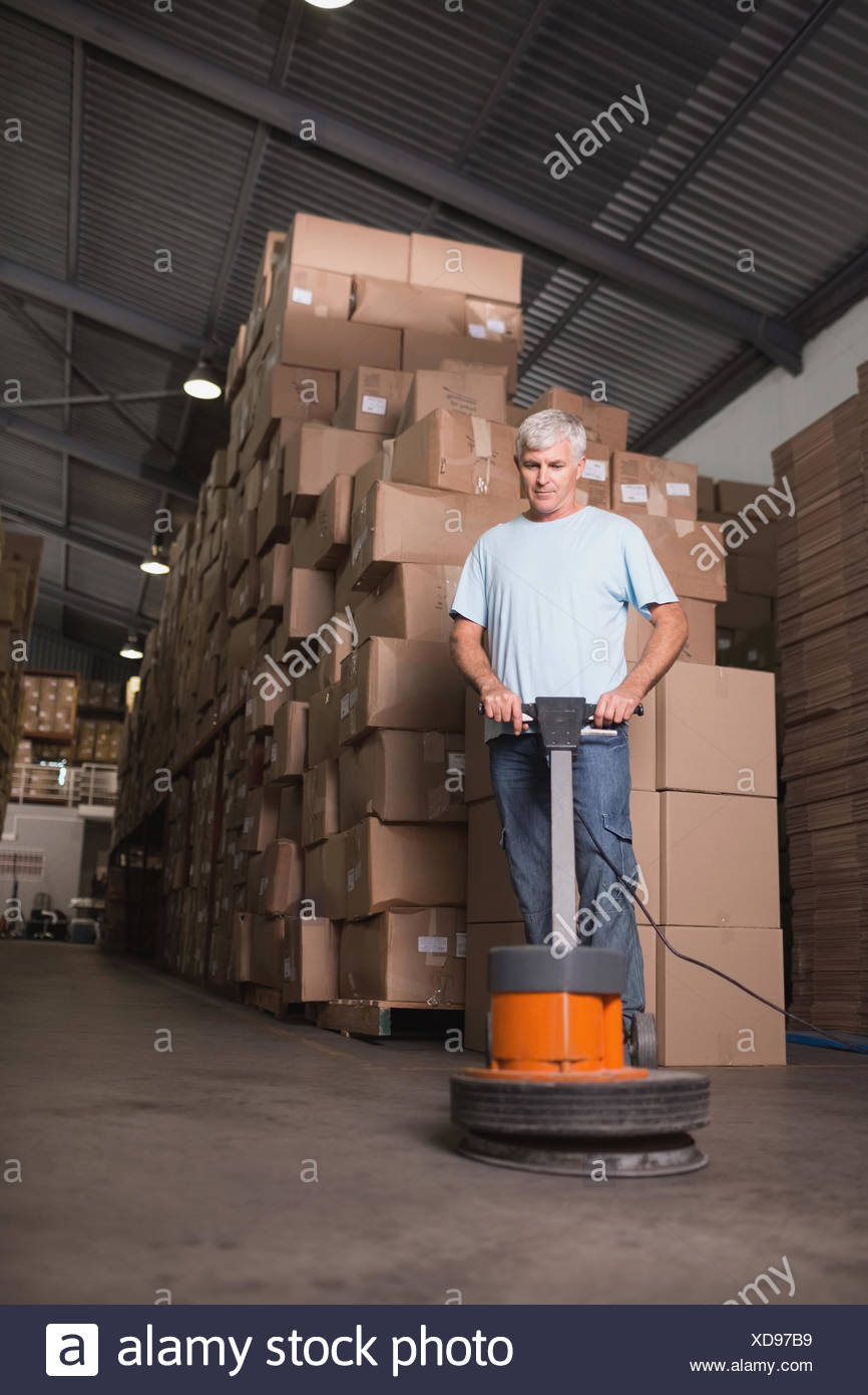 Man Cleaning Warehouse Floor With Machine Stock Photo 283559789