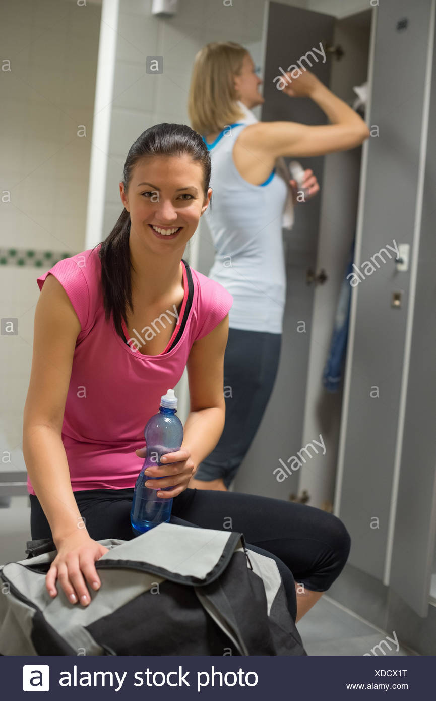 Smiling Woman With Friend In Background At Gym S Locker Room