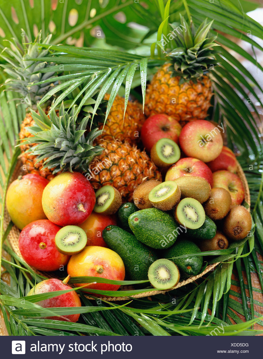 Basket Of Exotic Fruits And Leaves Stock Photo Alamy