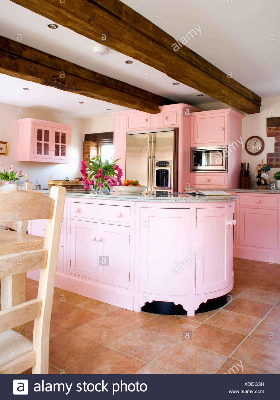 Pastel Pink Fitted Units And Beamed Ceiling In Country Kitchen With Terracotta Floor Tiles Stock Photo Alamy
