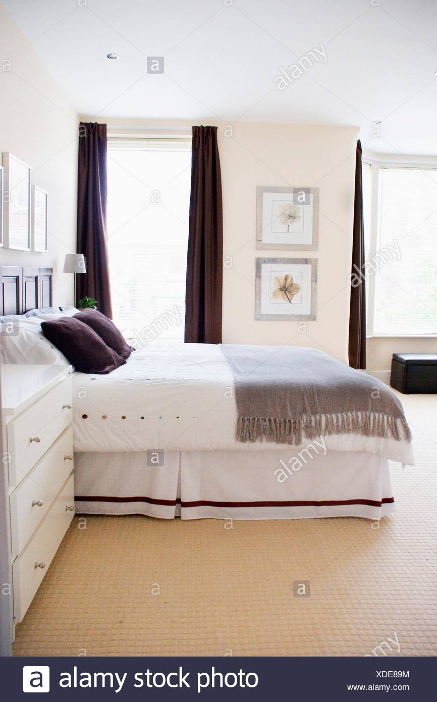 A Bedroom Decorated In Restful Tones Of Grey White Brown