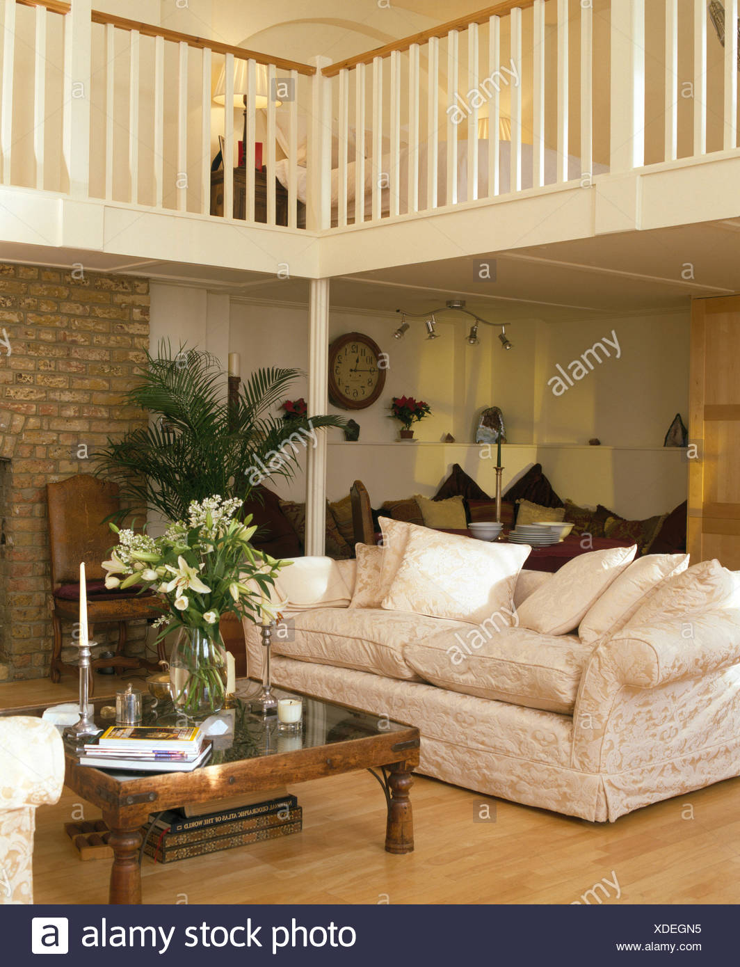 Cream Sofa And Indonesian Coffee Table With Vase Of White
