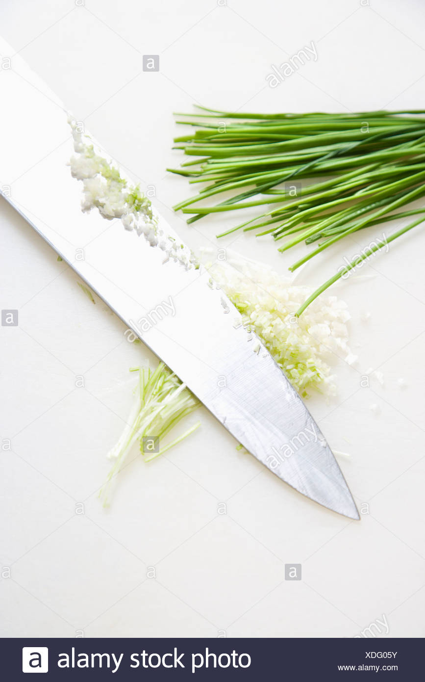 Freshly Chopped Chives With Kitchen Knife Resting On Countertop Stock Photo Alamy