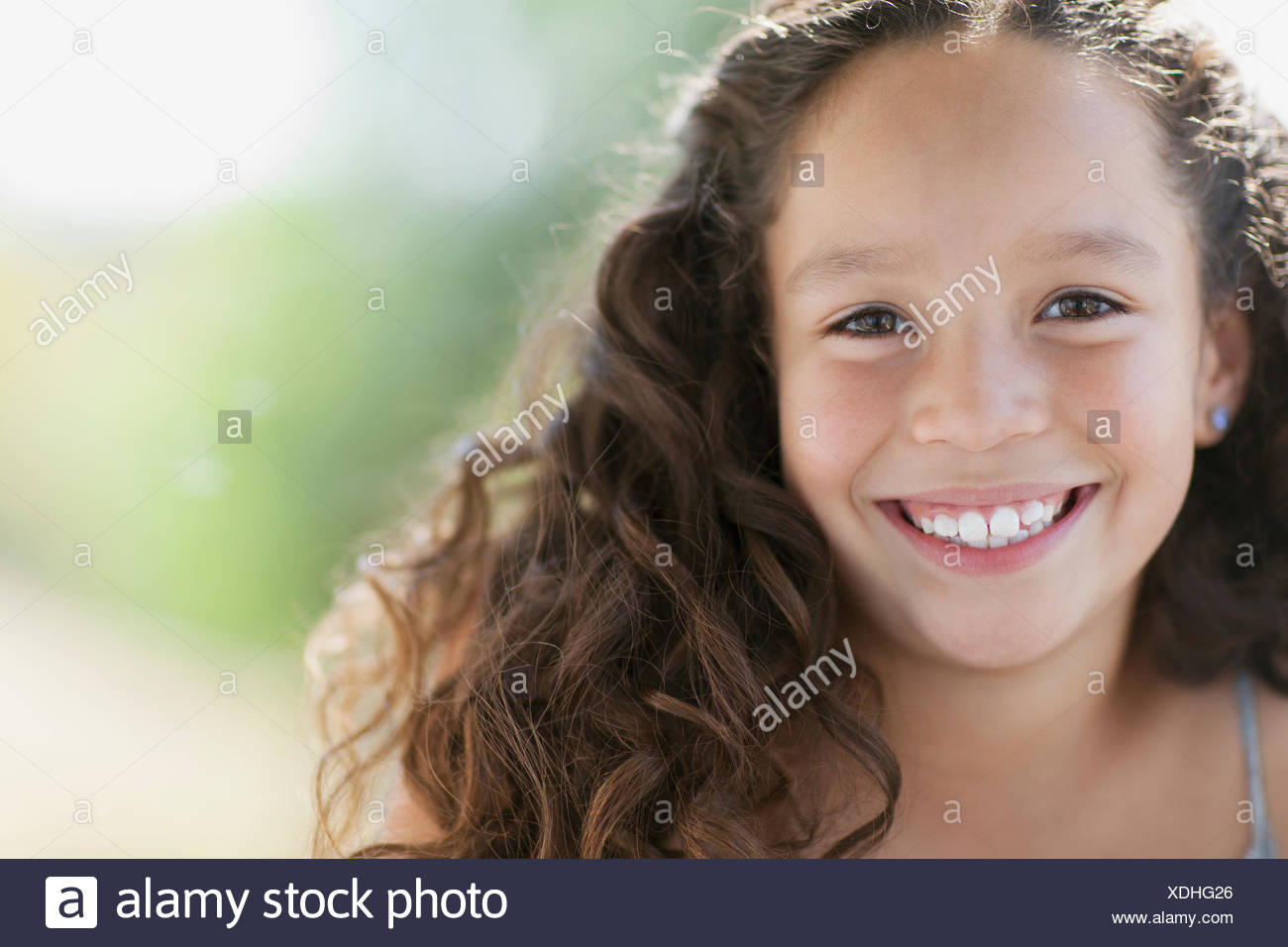 Portrait Of Pretty Eyed Elementary Aged Girl With Long Wavy Hair