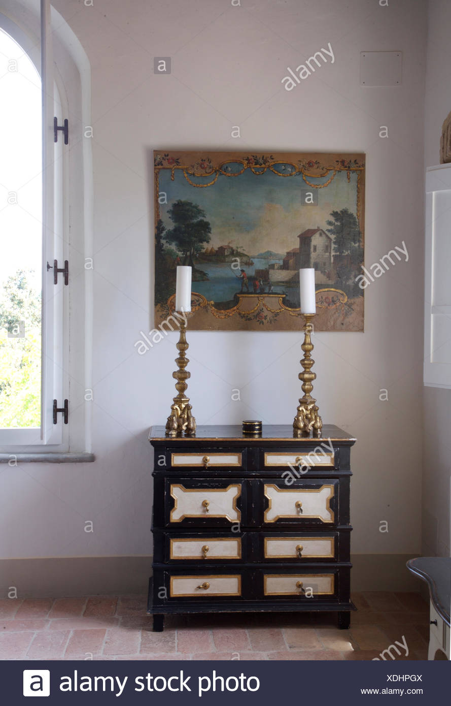 Tall Brass Candlesticks On Painted Antique Chest Of Drawers