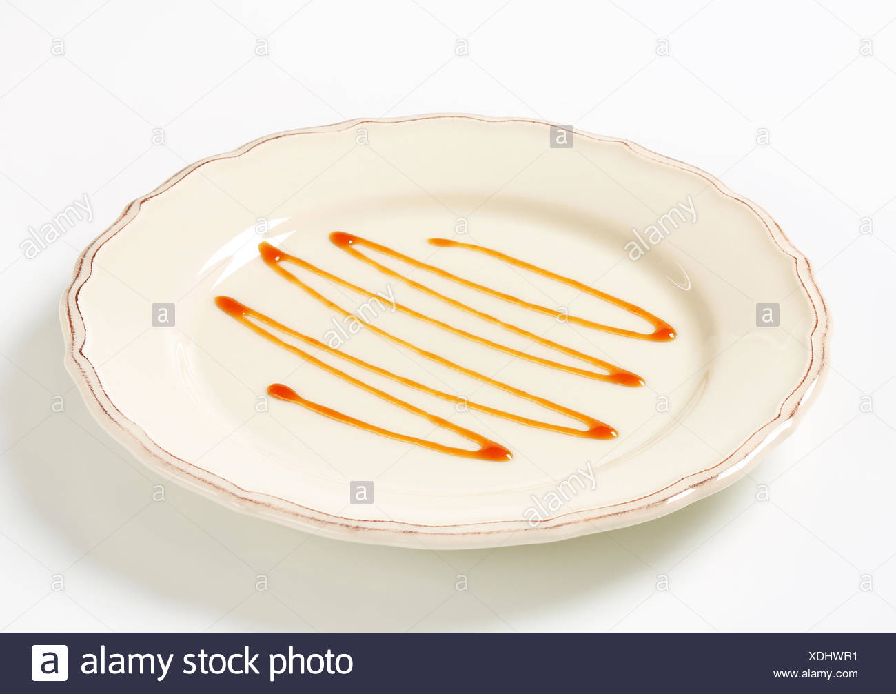 Caramel Drizzle Sauce Decoration On Plate Stock Photo