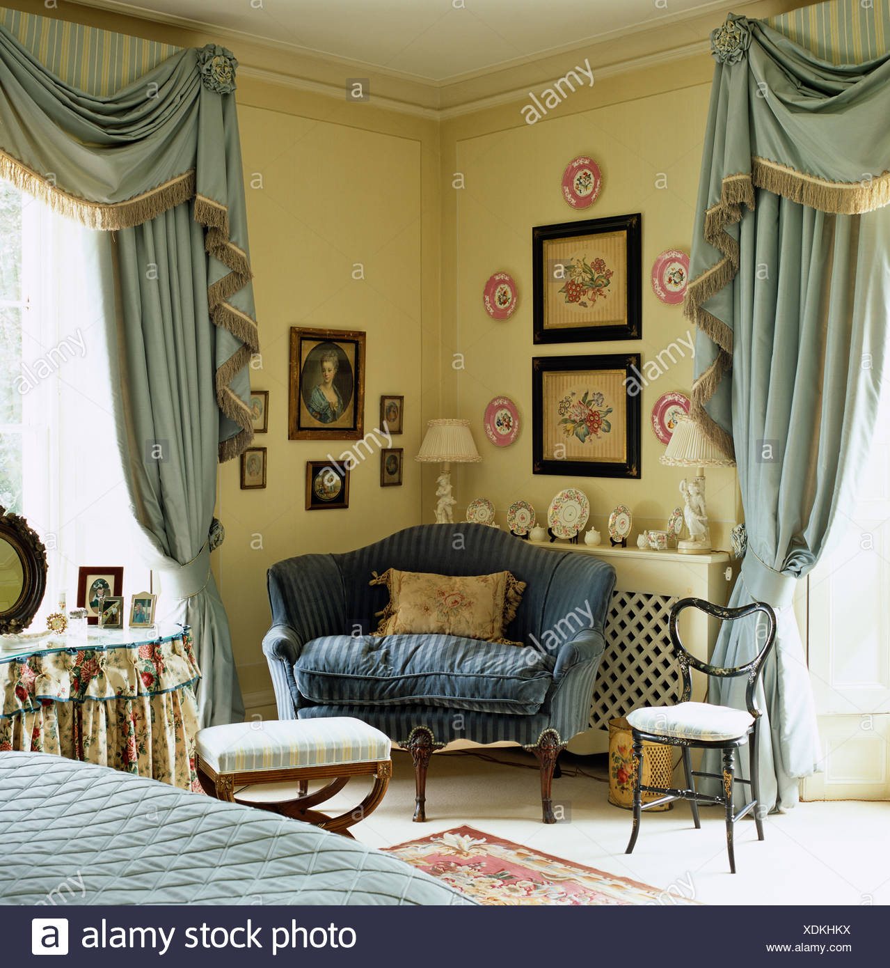 Small Blue Sofa In Corner Of Country Bedroom With Pale Blue Silk