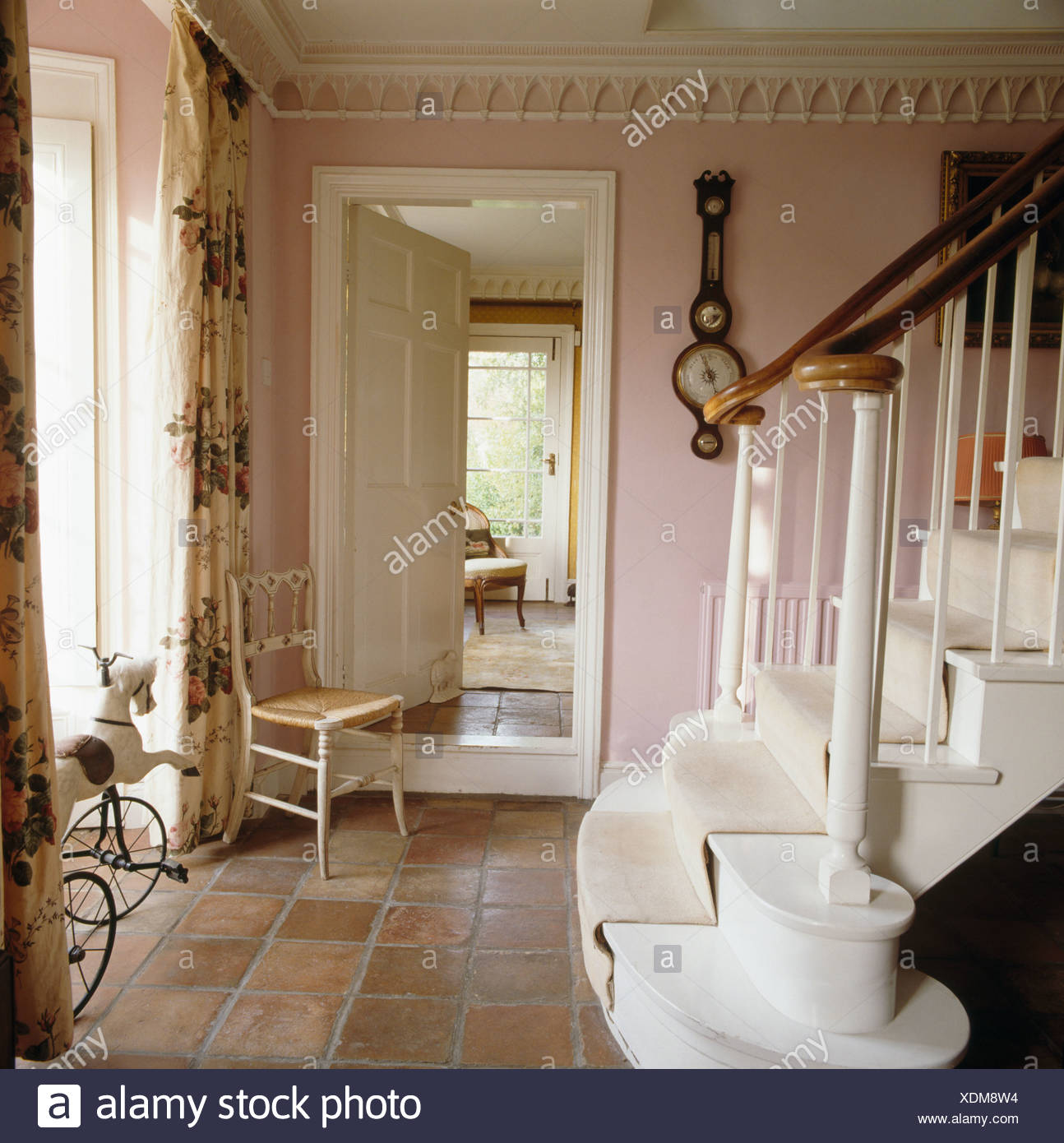 Antique Chair Beside Open Door To Dining Room In Pink Country Hall