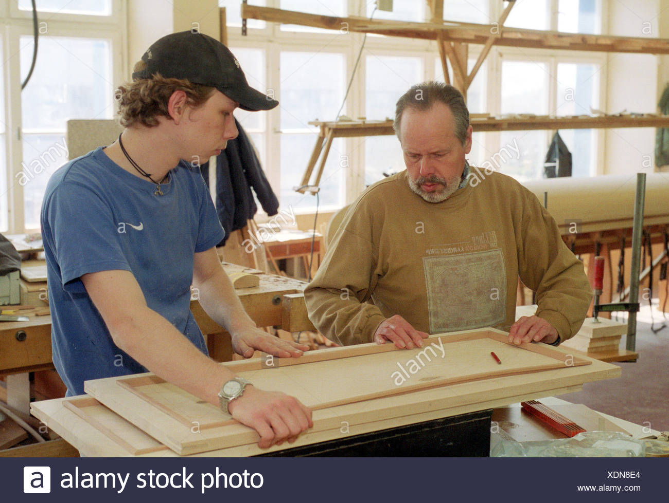 Berlin A Carpenter Apprentice Is Instructed By His Master Stock Photo Alamy