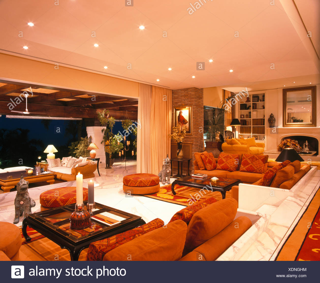 Orange Sofas And Rugs In Living Room In Large Spanish Villa With Open Doors To The Terrace Stock Photo Alamy