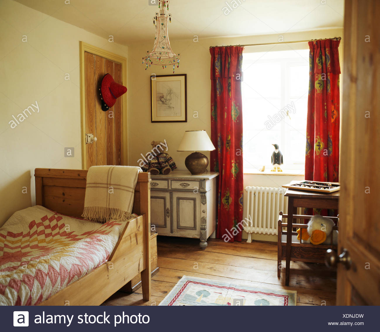 Patchwork Quilt On Pine Bateau Lit In Country Bedroom With Painted