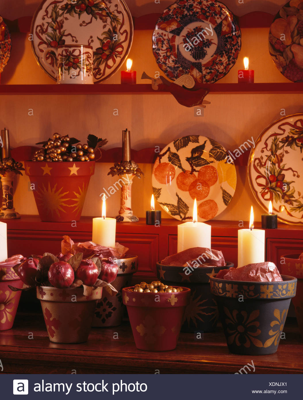 Close Up Of Candles In Flowerpots Decorated For Christmas On