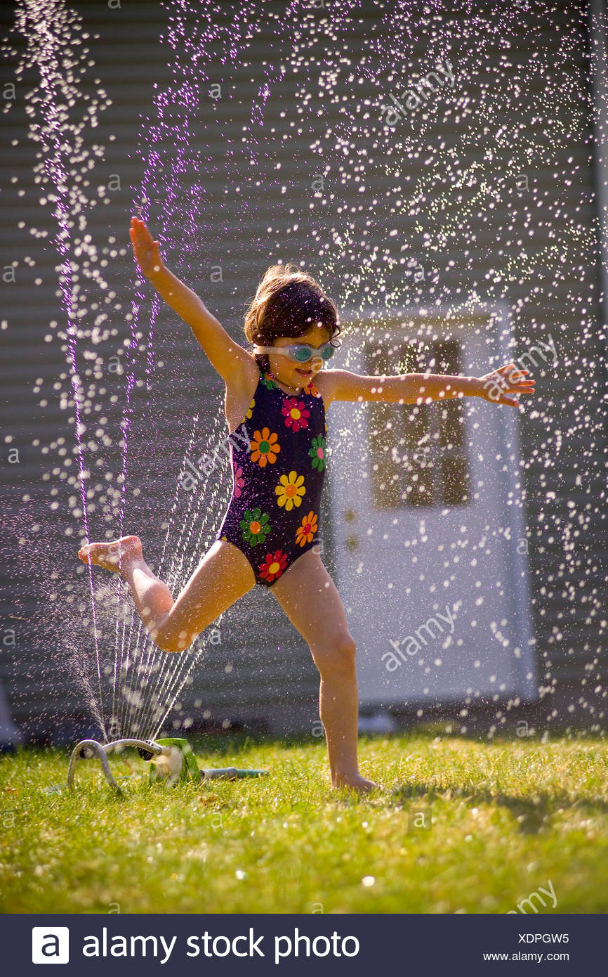 Girl Running Through Sprinkler Stock Photos & Girl Running Through